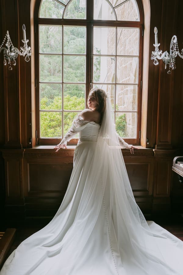 Bridal portrait beside a large window inside Gassaway Mansion.