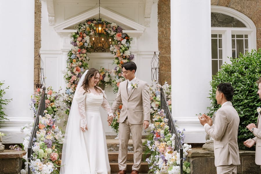 Bride and groom standing outside Gassaway Mansion in Greenville, South Carolina after their wedding ceremony.
