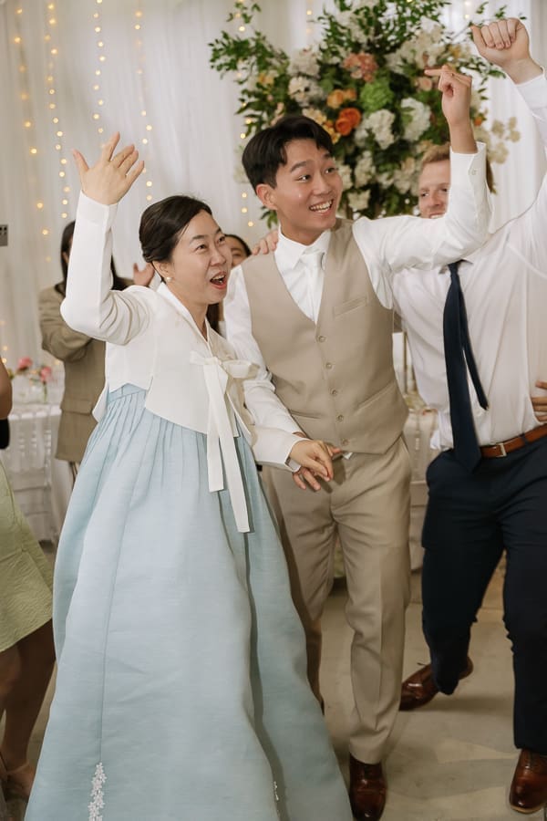 Bride and groom celebrating with guests during the wedding reception at Gassaway Mansion.
