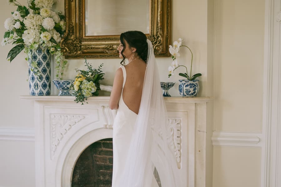 Bride standing near a historic fireplace during a wedding at Barnsley Resort in Adairsville, Georgia.