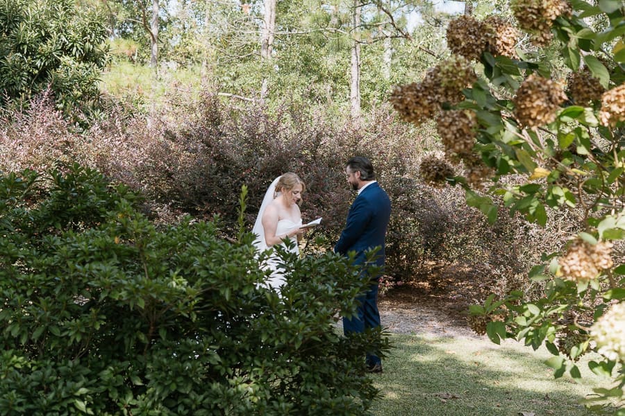 Bride and groom exchanging vows during an outdoor wedding ceremony at Swan House in Atlanta, Georgia.