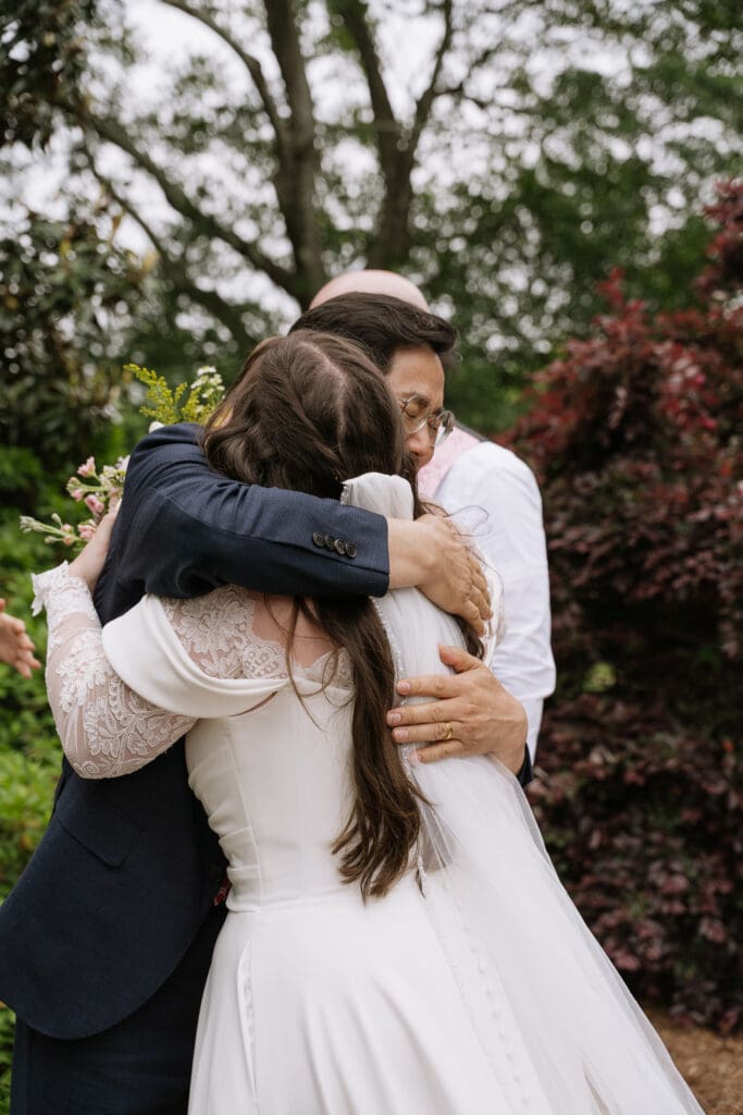 Newly married bride embracing a family member immediately after the wedding ceremony.