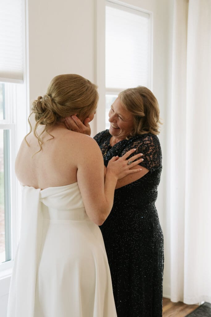 Bride sharing an emotional moment with her mother while getting ready on her wedding day.